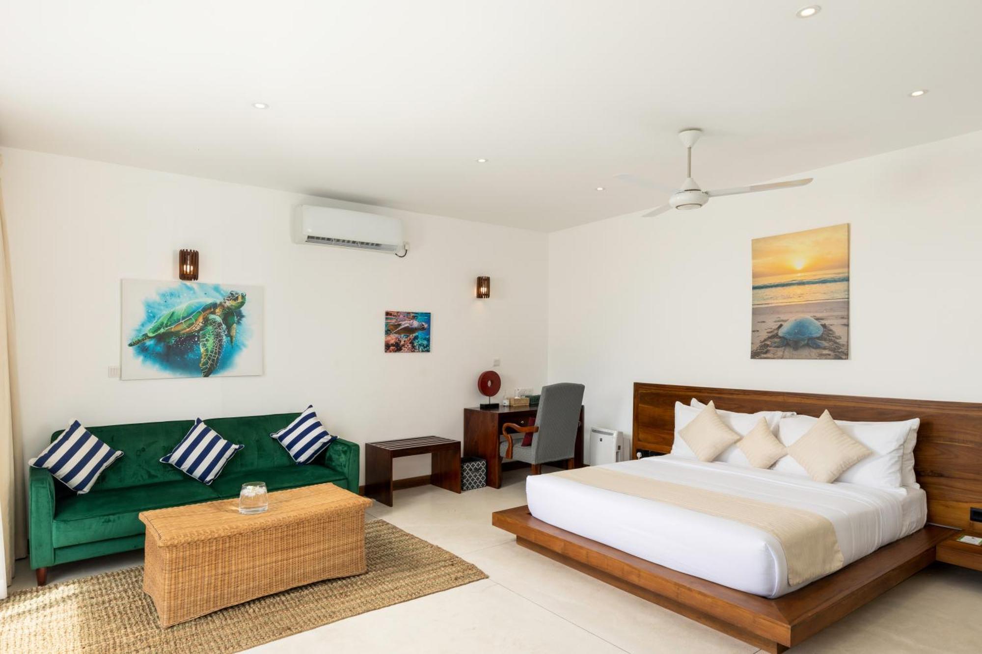 Deluxe Double Room with Balcony and Sea View with homemade Sorbet, a tropical evening mocktail, local snacks with tea/coffee, and a dining experience by the white sands